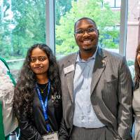 Four event attendees looking at camera and smiling